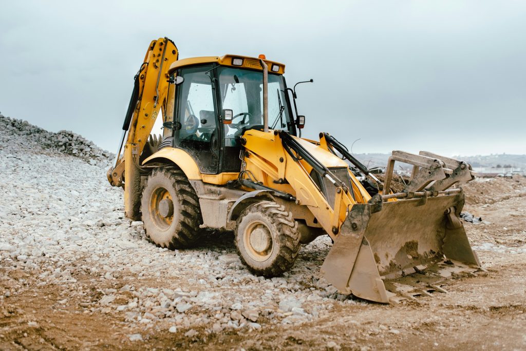 Industrial backhoe excavator loader and bulldozer machinery on construction site